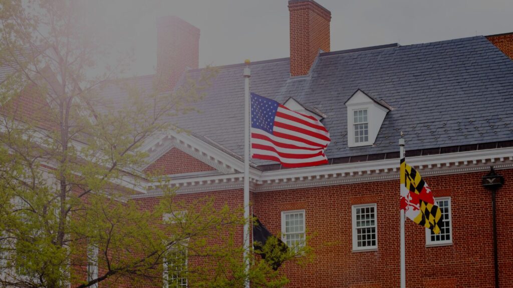 United States and Maryland flags flying in front of the Maryland State House in Annapolis